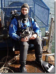 This 
  is me, next to the diving bell (used for surface supply diving) on Big Pearl. 
'High viz' clothing, steel capped boots and hard hats were the order 
  of the day.